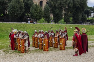 Traditional group of Roman legionaries soldiers lining up with large shield and swords next to