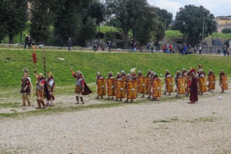 Traditional group Roman legionaries soldiers in line up with large shield and swords next to