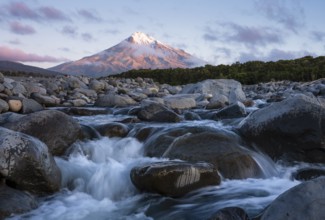Mount Taranaki in the evening at sunset, in the foreground Stony River (Hangatahua River) . Egmont