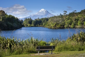 Park bench on Lake Mangamahoe with views of Mount Taranaki. Egmont National Park, Taranaki Region,