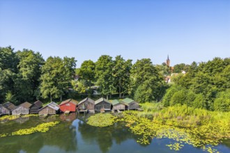 Aerial view, drone photo: house lake with city church and colorful boathouses on stilts, Feldberg,