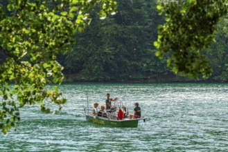 Manually operated ferry with ferryman and passengers, Lake Schmaler Luzin, Feldberg Lake District,