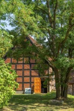 Sign open church in front of the half-timbered church in the village of Carwitz, Feldberger