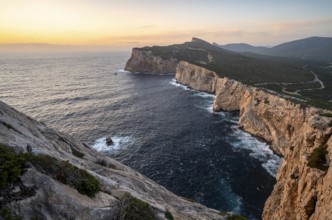 Coastal landscape at sunset, steep cliffs by the sea, cliffs in the evening light, Capo Caccia,