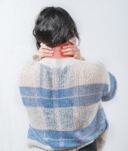 Close up female with neck pain. Woman in pain holding her neck isolated. Suffering woman with