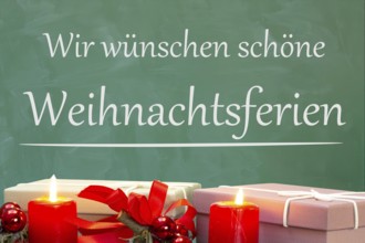 (Photo montage) Christmas decoration on a school blackboard with the inscription WE WISH YOU HAPPY