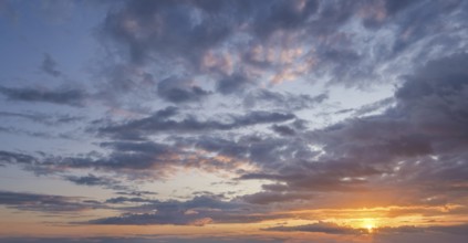 At sunset vibrant colors fill the sky, creating a stunning backdrop with dramatic clouds, perfect