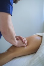 A skilled therapist performs a soothing leg and thigh massage using oil, promoting relaxation and