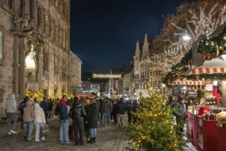 Entrance to Nuremberg Christmas Market illuminated in the evening, with town hall, main market,
