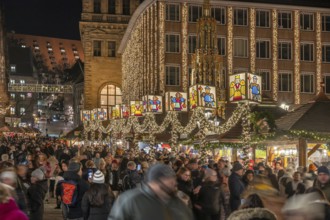 Nuremberg Christmas Market illuminated in the evening with the Beautiful Fountain and Town Hall,