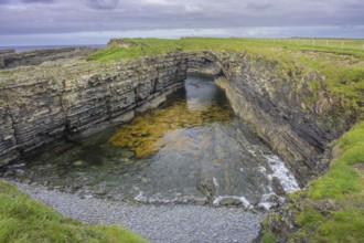 Bridges of Ross rock arch, Kilballyowen, County Clare, Ireland