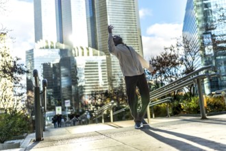 Man finding personal freedom and expressing himself through expressive urban dancing on a public