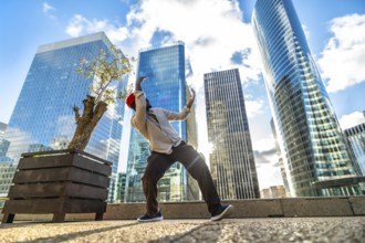 African american man performing contemporary dance in la defense urban plaza, full length