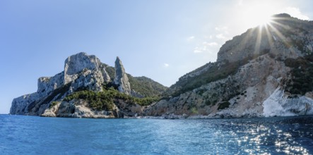 Light blue clear sea on a dream beach on Cala GoloritzÃ©, picturesque rocky coast with sun stars,