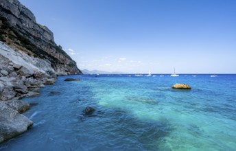 Light blue clear sea on a dream beach on Cala GoloritzÃ©, picturesque rocky coast, cliffs, Golfo di