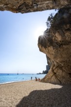 Sandy beach beach and steep cliffs at Cala Luna, Sun Star, Golfo di Orosei, Baunei, Sardinia, Italy