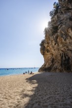 Sandy beach beach and steep cliffs with caves at Cala Luna, Sun Star, Golfo di Orosei, Baunei,