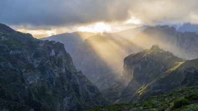 Sunset at Pico do Arieiro, sun shining through clouds, sunbeam, hiking trail PR1, Madeira, Portugal