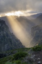 Sunset at Pico do Arieiro, sun shining through clouds, sunbeam, hiking trail PR1, Madeira, Portugal