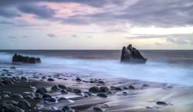 Sunset, waves and rocks in the sea, Praia Formosa, Madeira, Portugal