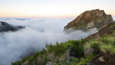 Sunrise at Pico do Arieiro, clouds of fog sweep over mountain peaks, sea of fog, hiking trail PR1,