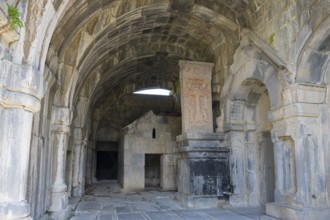 Vaulted stone building with decorated arches and historic reliefs in old walls, Haghpat monastery,