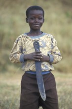 Portrait of a little boy with a big knife, Bwangu Mzimba, Malawi, Africa, June 2000, vintage,