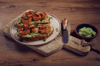Sandwiches with avocado and caramelized shrimp, micro-greens, breakfast, on a plate, top view,