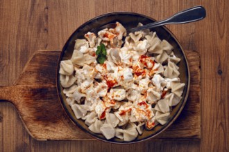 The dish features a generous serving of Turkish dumplings topped with velvety yogurt and a drizzle