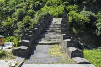 Historic stone staircase leads through a wooded landscape covered with moss, bridge, Sanahin bridge