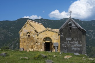 Historic church in the middle of a green mountain area under blue sky with clouds, Saint Nshan