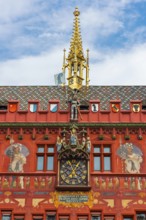 Exterior view with a magnificent clock at the Red Town Hall, Market Square, Basel