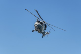 Military helicopter in blue sky
