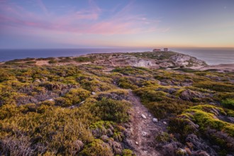Cabo Espichel cape Espichel on Atlantic ocean at sunset with ruins