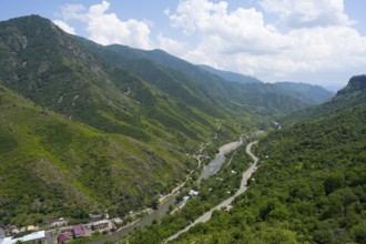 A valley with a river and a road nestled in green hills and under a cloudy sky, Debed River, Debed