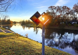 Sunrise over the Lippe river with the sign of the discovery route Wasser Wege Winkel, Lippeaue,