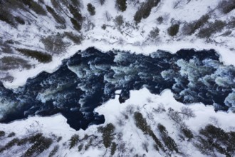Aerial view over rapids in the river Kitkajoki in winter, Oulanka National Park, Northern