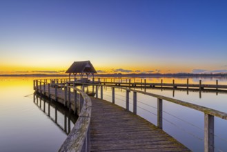 Wooden jetty on Lake Hemmelsdorf / Hemmelsdorfer See at sunrise in spring near LÃ¼beck,