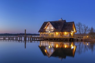 LakehouseÂ°54, bistro and bar on Lake Hemmelsdorf / Hemmelsdorfer See at sunrise in spring near