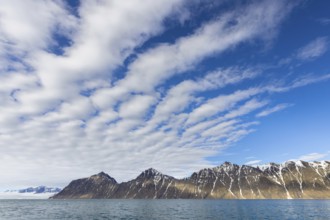 White clouds over mountains along Lilliehöökfjorden, fjord branch of Krossfjorden in Albert I Land,