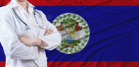 Doctor with crossed arms on Belize flag. Belizean health and care concept. Female doctor on Belize