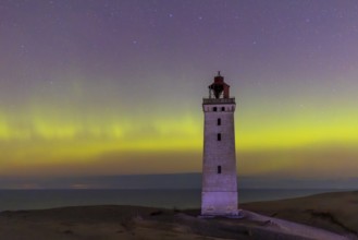 Northern lights / Aurora borealis over Rubjerg Knude Fyr, lighthouse in the dunes on top of