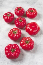 Pink tomatoes scattered on the table, top view, close-up, no people