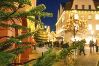 Christmas market lighting in an urban environment with tree balls in the foreground, Christmas