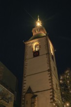 Historic church tower brightly lit at night, Christmas market 2025, Nagold, Black Forest, Calw