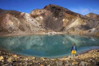 A hiker at one of the Emerald Lakes and Red Crater, Panorama, Tongariro alpine crossing, Tongariro