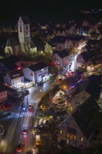 Aerial view of a festively lit village with Christmas lights and church, Aidlingen Christmas