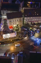 Night view with decorated Christmas tree and people gathered, Aidlingen Christmas market, Böblingen