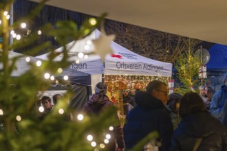 Christmas market with people and fairy lights in the background, Aidlingen Christmas market,