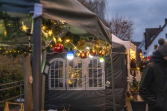 Atmospheric Christmas lights at market stalls at dusk, Aidlingen Christmas market, Böblingen